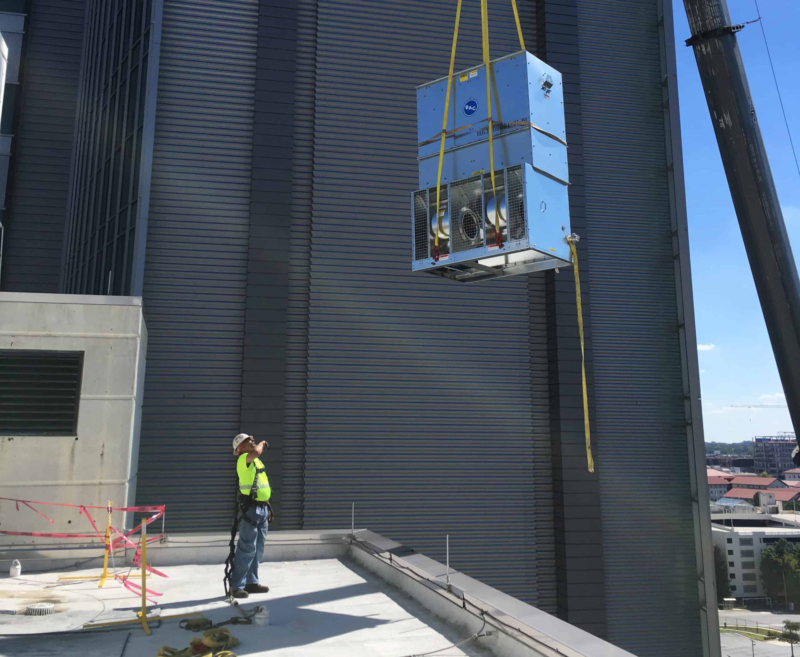 FSE Employee Help Lower Equipment from a Crane
